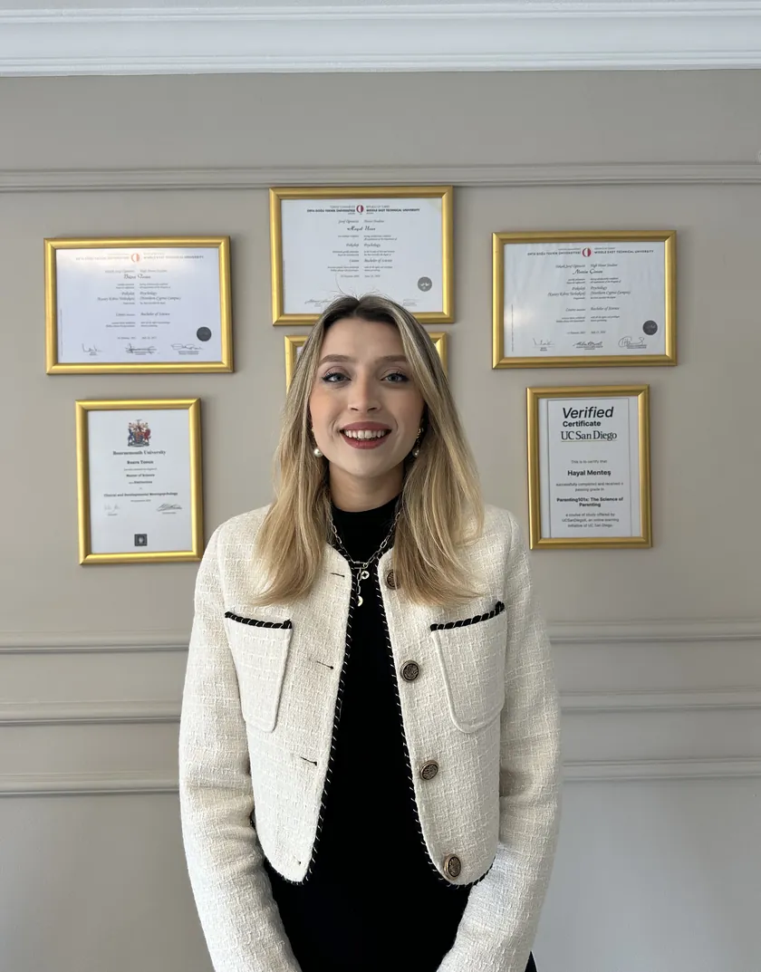 Büşra Tosun, diplomalarının önünde